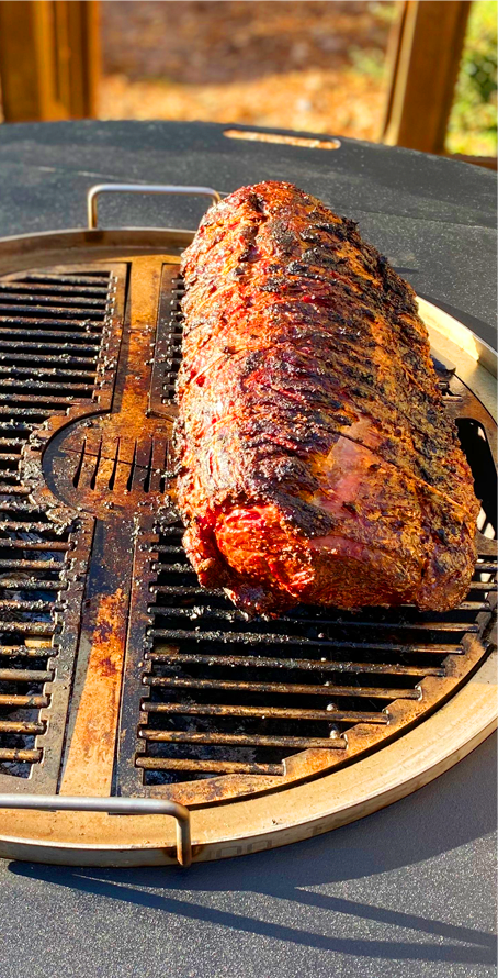 Beef brisket being cooked on the gather grill